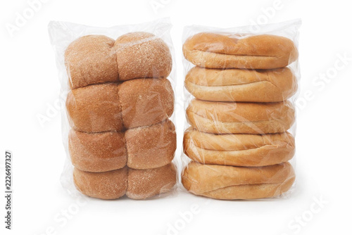 Packaged Whole Wheat and White Bread Rolls in Transparent Plastic Bags Isolated on White Background