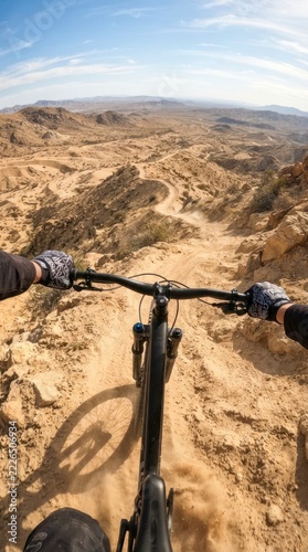 Point of view shot of mountain biking down a steep desert trail, adventurous off-road cycling ride.