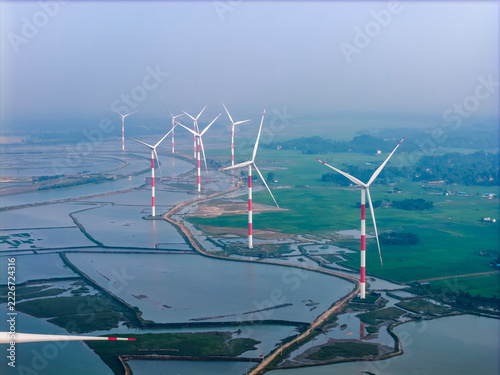 Fotografie Panoramic Aerial View of Wind Power Turbines Installed Across Coastal Wetlands and Salt Pans in Cox's Bazar, Bangladesh