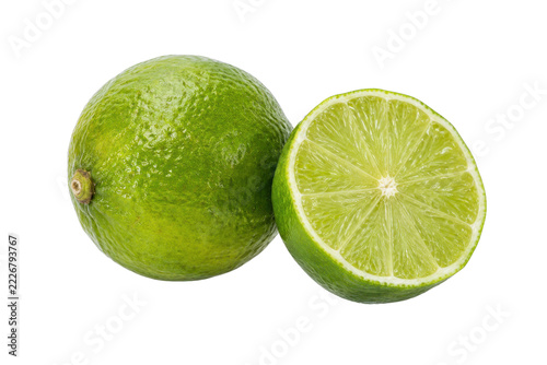 Vibrant whole green lime and a perfectly sliced half lime are presented with bright studio lighting on a clean white background