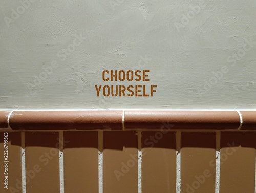 Brown wall with typography  Choose Yourself  - means putting your physical, mental and emotional well-being first instead of pleasing others to gain approval