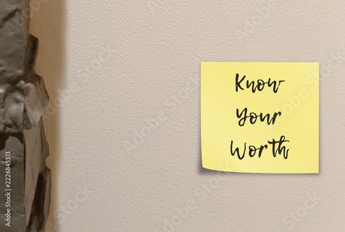 Paper note stick on a wall written Knowing Your Worth - means recognizing your value as a person— external status, social media likes, or other people's approval.