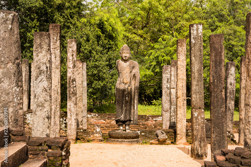 Ancient Buddha Statue Amidst Stone Pillars in Polonnaruwa, Sri Lanka