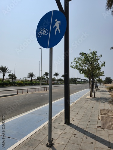 Typical Jeddah Raised Sidewalk with Bike Lane and Pedestrian Sharing Signage on a Service Road along a Main Road in Jeddah KSA