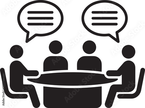 A black vector icon of four business people sitting around a meeting table with speech bubbles illustrating communication and collaboration.