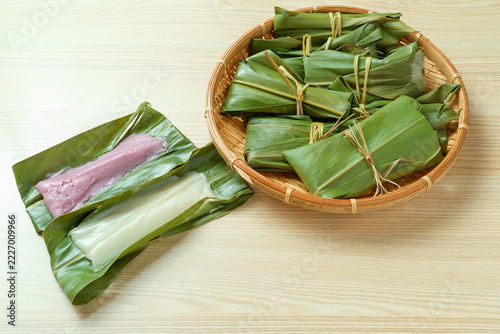 White and Purple Moochi on Leaves beside a Basket of Leaf Parcels