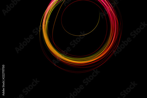 A stunning freeze light circle in vibrant colors spins in the darkness, creating intricate patterns in the night air