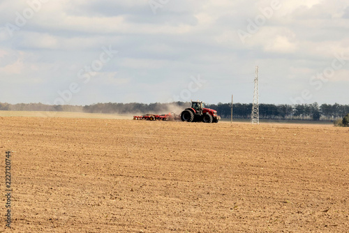 Specialized machinery. A modern tractor is sowing grain crops.