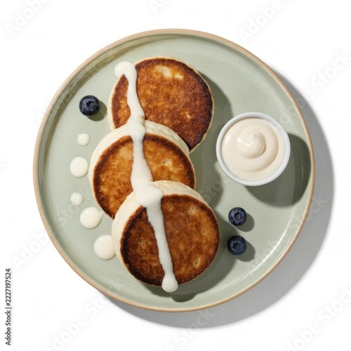 Luxury cookbook style food photography featuring fluffy syrniki, creamy edges and white ramekin of milk — ultra detailed overhead shot for sweet breakfast and dairy product concept