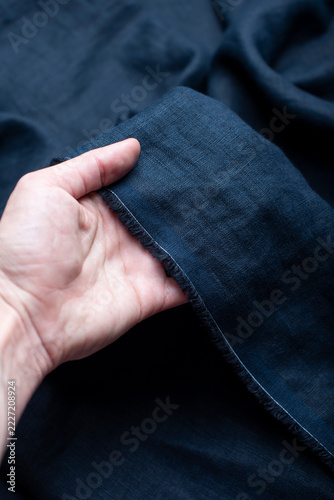 Hand Holding Raw Edge Dark Navy Blue Linen Fabric