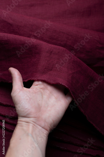 Hand Holding Burgundy Wine Red Linen Fabric Edge