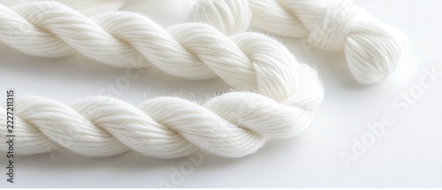 White twisted rope displayed on a plain background, highlighting its smooth texture and sturdy construction for various uses and crafts