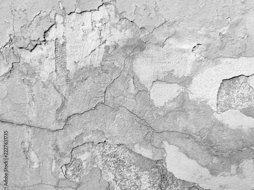 Textured old deteriorated plastered wall with cracks and peeling paint. Vintage background with grunge aesthetic. Copy space. Close-up. Selective focus.