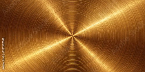 Abstract brushed brass texture with a radial pattern, emanating a warm, metallic glow.