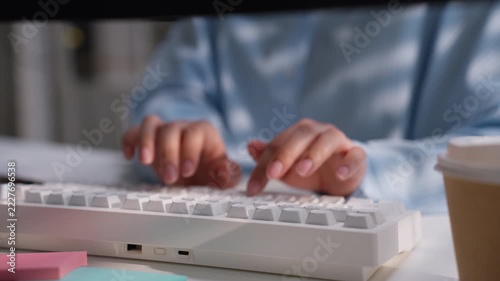Office worker typing on a white computer keyboard at a clean desk, illustrating business data entry, digital accounting workflow, administrative productivity, and professional office technology.