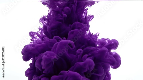Purple ink cloud swirling and dissolving in clear water, abstract dynamic motion, slow-motion footage, background for design, visual effect.