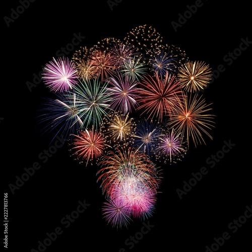 Fireworks of various colors and shapes burst in night sky