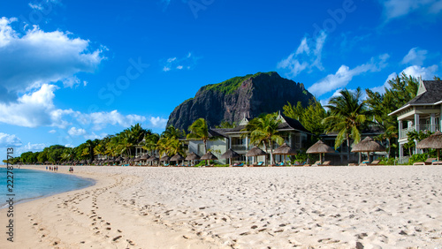 Le Morne beach in Mauritius, with beach huts and Le Morne Brabant mountain