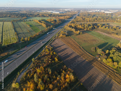 Aerial view of a motorway leading towards Stryków through an autumn rural landscape, Poland