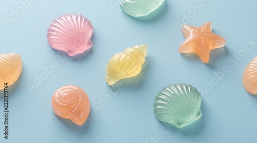 Glossy Gummy Seashells Arranged Neatly On Light Blue Surface Background