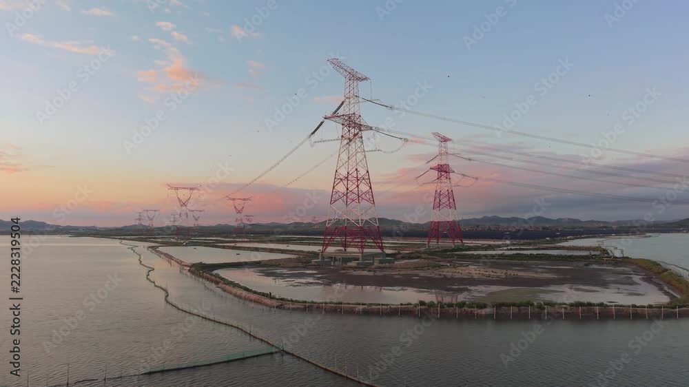 Sundet Line Model High voltage transmission towers and power lines over water at sunset ...
