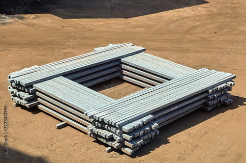 Square stack of steel billets stored outdoors in a steel mill industrial yard