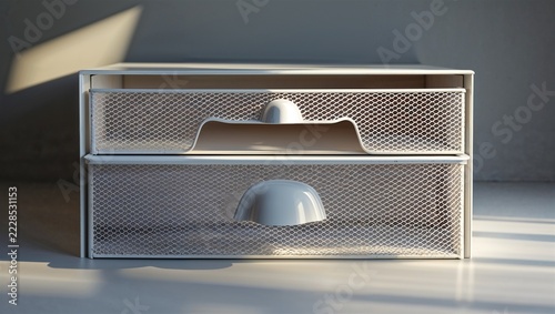 Two drawer silver mesh organizer in soft window light
