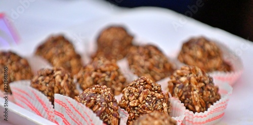 Crispy chocolate cereal truffle balls placed in small paper cups