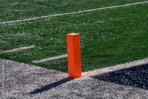 Bright Orange Football Pylon Marking End Zone Corner on Green Artificial Turf Field