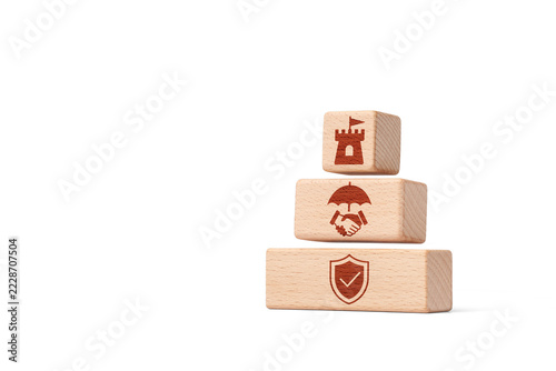 Risk management with wooden blocks featuring security, protection and trust icons on white background