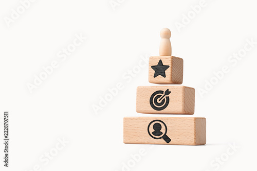 Centricity concept with wooden figure on strategy pyramid and customer focus
