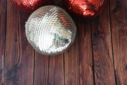 Top view of red and silver sequin Christmas baubles with sparkling glitter details, festive holiday decorations, elegant seasonal background, and shimmering metallic textures.