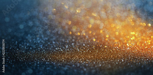 Blue and Gold Glitter Background with Glowing Bokeh Highlights