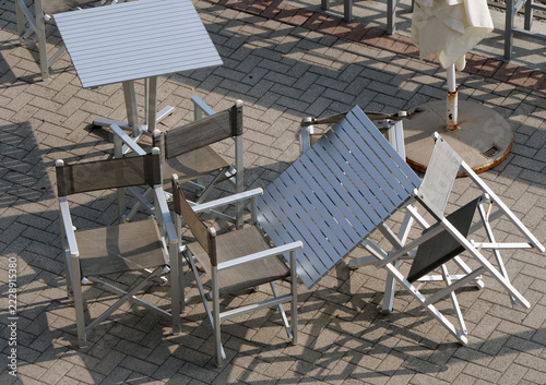Tables and chairs on a terrace by the sea
