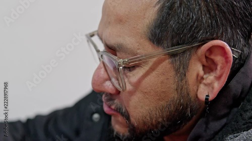Focused bearded man wearing glasses working