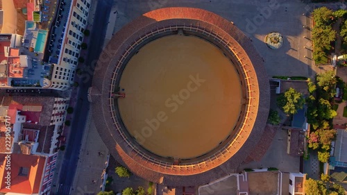 Top down aerial of the circular Ronda bullring set among the streets of the town, Spain.