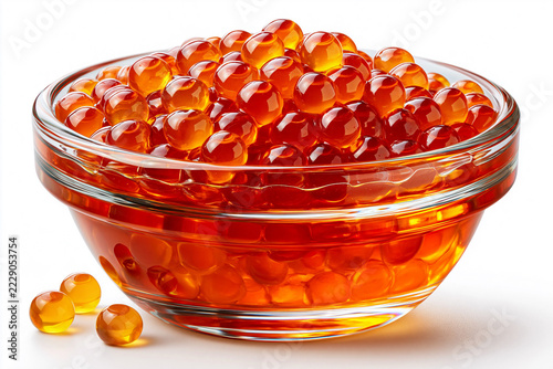 Glass bowl filled with orange fish roe on a white background