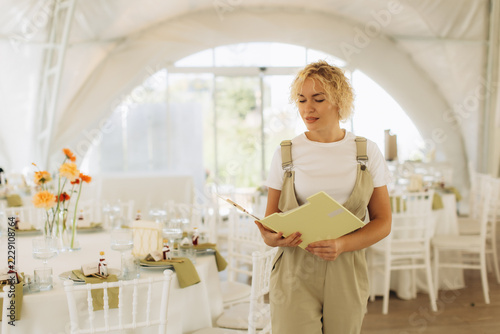 Event planner organizing a wedding banquet in a tent