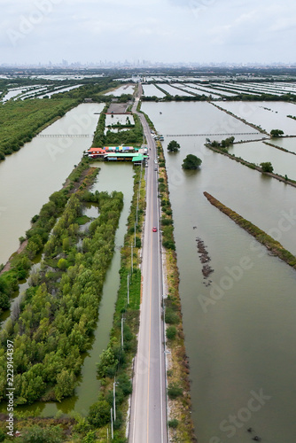 Aerial view of an asphalt road through Na Klea district in central Thailand.