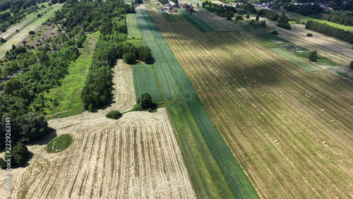 Obraz na plátně Aerial landscape of farm fields under cloudy sky