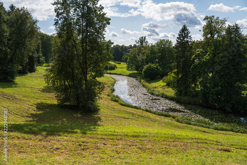 Picturesque winding river valley through lush summer greenery