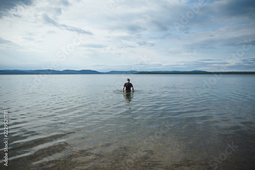 A young boy swimming in Batchewana Lake in Ontario, Canada.