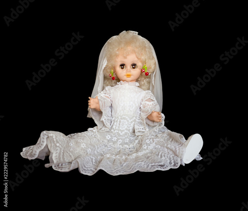 Miniature toy doll on a black background.