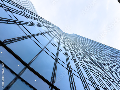 glass office buildings reflecting blue sky