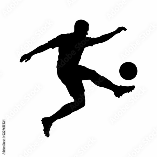 Black silhouette of a soccer player kicking a ball in mid-air isolated on white background