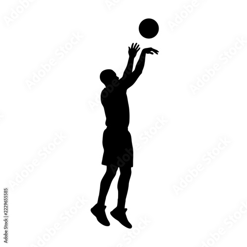 Black silhouette of a male basketball player performing a jump shot with the ball flying towards the hoop isolated on white background