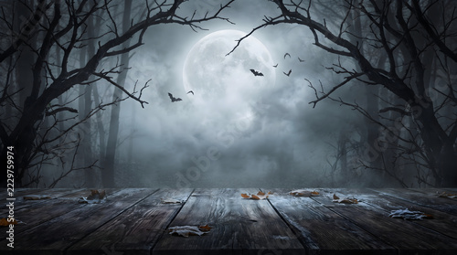 Spooky Halloween forest background with full moon and empty wooden table