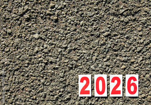 Huge numbers of 2026 year. Paper square numbers on the stone road background. Autumn of year of 2026, year of the red fire horse. Numbers of current, passing year. Symbols of 2026