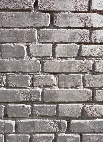 Brick wall texture, background in black color. Wall backdrop. The building wall, painted with dark water-based paint. Brick exterior in a dark, glossy finish. A grayish-black designer finish on wall