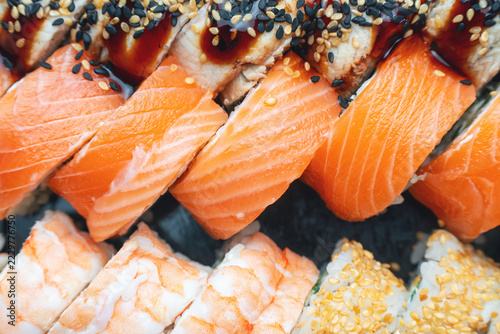 Close-up of an assortment of sushi with salmon, shrimp, and sesame seeds. Fresh Japanese seafood